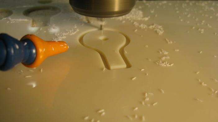 cutting a tensile test specimen on a CNC machine