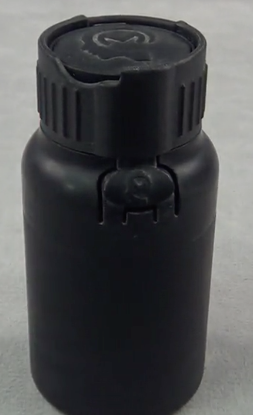 Four piece child safe bottle with novel living hinge opening mechanism