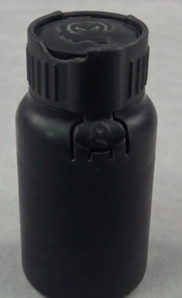 Four piece child safe bottle with novel living hinge opening mechanism
